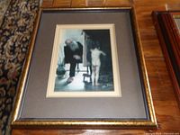 Rectangular framed print of elderly man with nude child, gold trim frame, brown mat