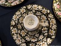 Cup sitting on saucer and plate, showing underside mark 'Royal Albert Bone China England Provincial Flowers Prairie Crocus'