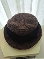 Top view of brown chenille cloche hat with velvet band