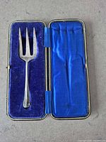 Fork in open blue velvet/satin presentation case