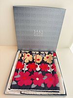 Scarf folded in open Saks Fifth Avenue box showing floral pattern