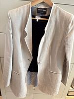 Front view of light gray Armani Collezioni blazer on hanger