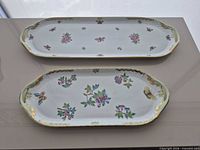 Both Herend trays top view showing pattern and size difference