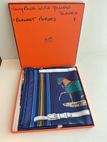 Folded Hermes silk scarf in original orange box