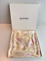 Scarf displayed inside open Holt Renfrew box