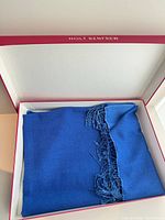 Folded blue pashmina with fringe inside Holt Renfrew box
