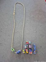 Full view of gold-plated necklace and nine loose beads