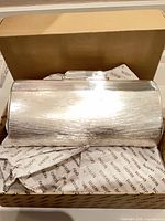 Clutch in box on branded tissue