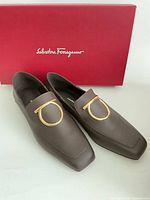 loafers front and side view with box showing brand logo