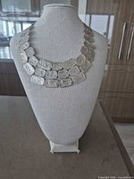 Front view of full necklace on display bust showing link design and overall shape