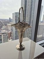 Front view showing full height, handle, filigree rim, pedestal base