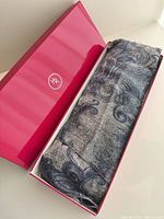 Scarf folded inside Holt Renfrew pink box
