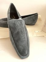 pair of slate blue suede loafers angled front view