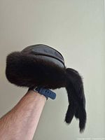 Fur hat side view showing leather crown and fur trim