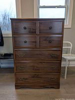 Front view showing all five drawers and hardware