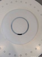 front view of round ceiling light fixture showing frosted diffuser