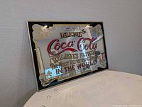 Angled view of full framed Coca-Cola glass sign