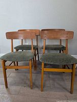 Four Farstrup teak chairs front view
