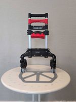 Hand truck folded halfway standing on table