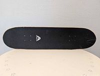 Top view showing black grip tape and Arcade logo