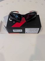 Front view of Comaxsun sunglasses on retail box