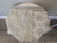 Two placemats showing both color sides and fringe detail