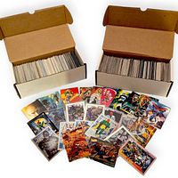 Two long boxes filled with Marvel trading cards and sample cards spread in front