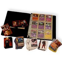 Open binder showing Pokémon cards, multiple loose stacks of Magic, Yu-Gi-Oh, soccer and assorted cards