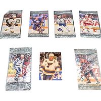 Assortment of sealed foil-wrapped mini NHL cards and one loose card displayed