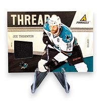 Front of Joe Thornton Panini Pinnacle Threads patch card showing player image and patch window