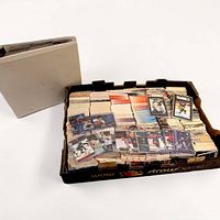 Overall lot showing produce tray filled with stacked hockey cards next to a long card storage box