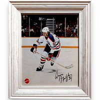 Front view of framed Wayne Gretzky photo showing action image, Mattel logo, printed autograph and frame style