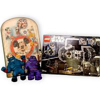 Group shot of boxed LEGO set, pinball game, and two stretch figures