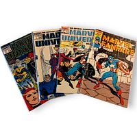 Front covers of four Marvel comic books: three Official Handbook of the Marvel Universe Deluxe Edition issues and Marvel Fanfare #31