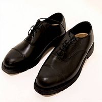 Pair of black cap toe Oxford dress shoes displayed side by side