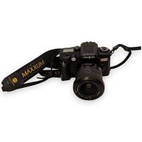 Front angled view of Minolta Maxxum 70 camera with attached AF Zoom lens and strap