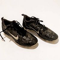 Pair of black marble Nike football cleats side view