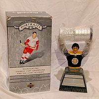 Front view of bust beside retail box