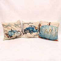 Front view of three fall themed throw pillows showing designs and size