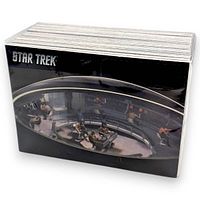 Stack of Star Trek trading cards, front card shows bridge scene, STAR TREK logo visible