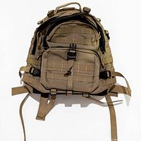 Front view of tan MOLLE tactical backpack showing pockets, webbing and straps