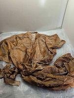 Full view of bronze silk robe laid flat with belt