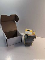 Open storage box beside stacked Pokémon cards