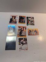 Eight Wayne Gretzky cards laid out on white surface