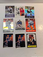 Nine hockey cards laid out in three-by-three grid