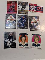 Nine hockey cards laid out, overall view