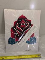 Front view of entire art print in sleeve with measuring tape for scale