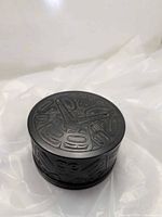 Top view showing carved Haida motif on lid and sides