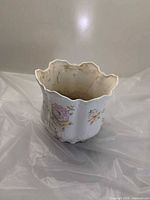 Exterior of white bone china planter with rose design