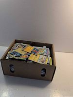 Closed view of cardboard box filled with Pokémon cards